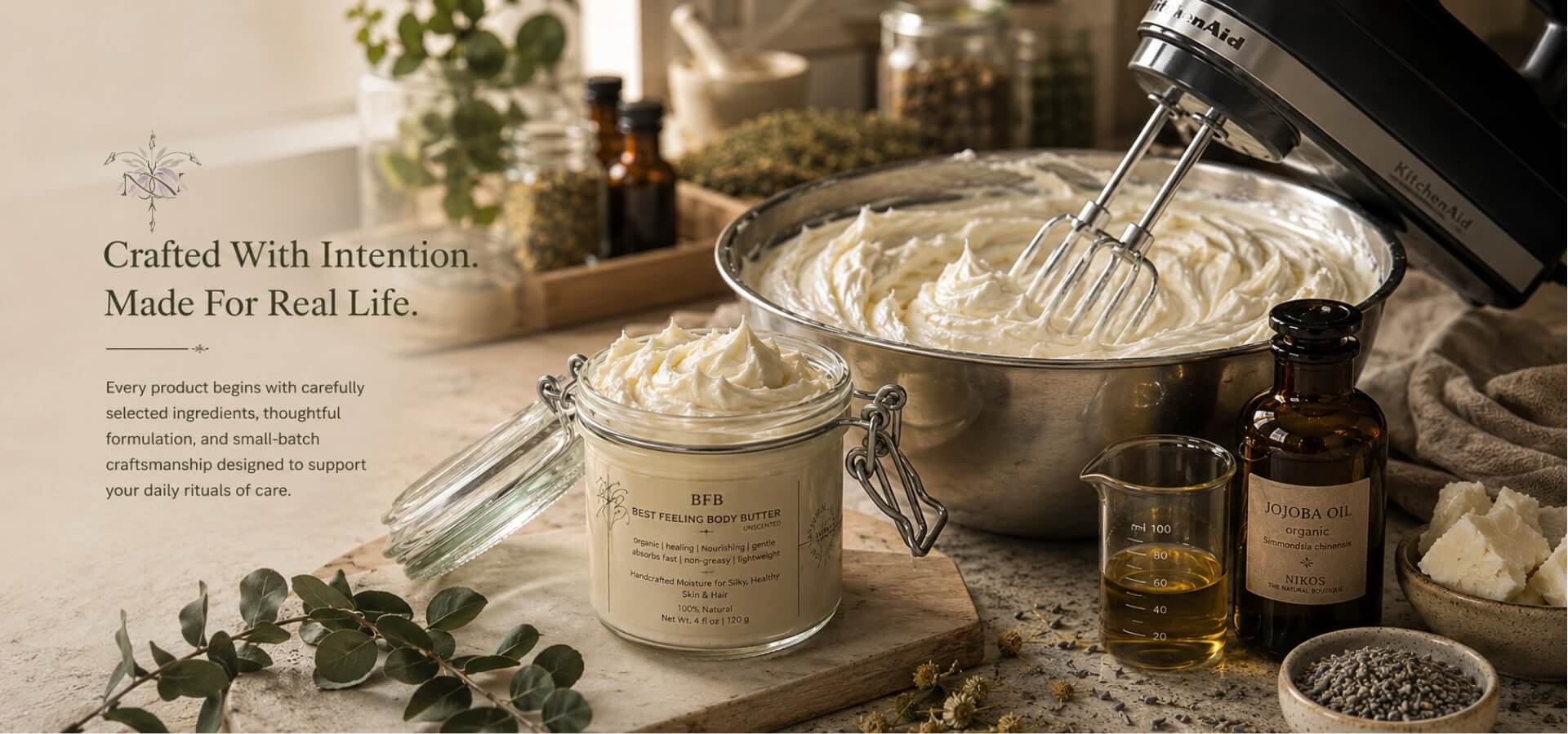 Bowl of whipped body butter, jar of body butter, and various ingredients on a wooden surface with text about intentional and real-life products.